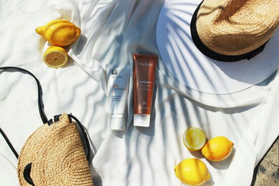 Summer health essentials including sunscreen, water bottle, fresh fruits, sunglasses, and hat for staying healthy during summer